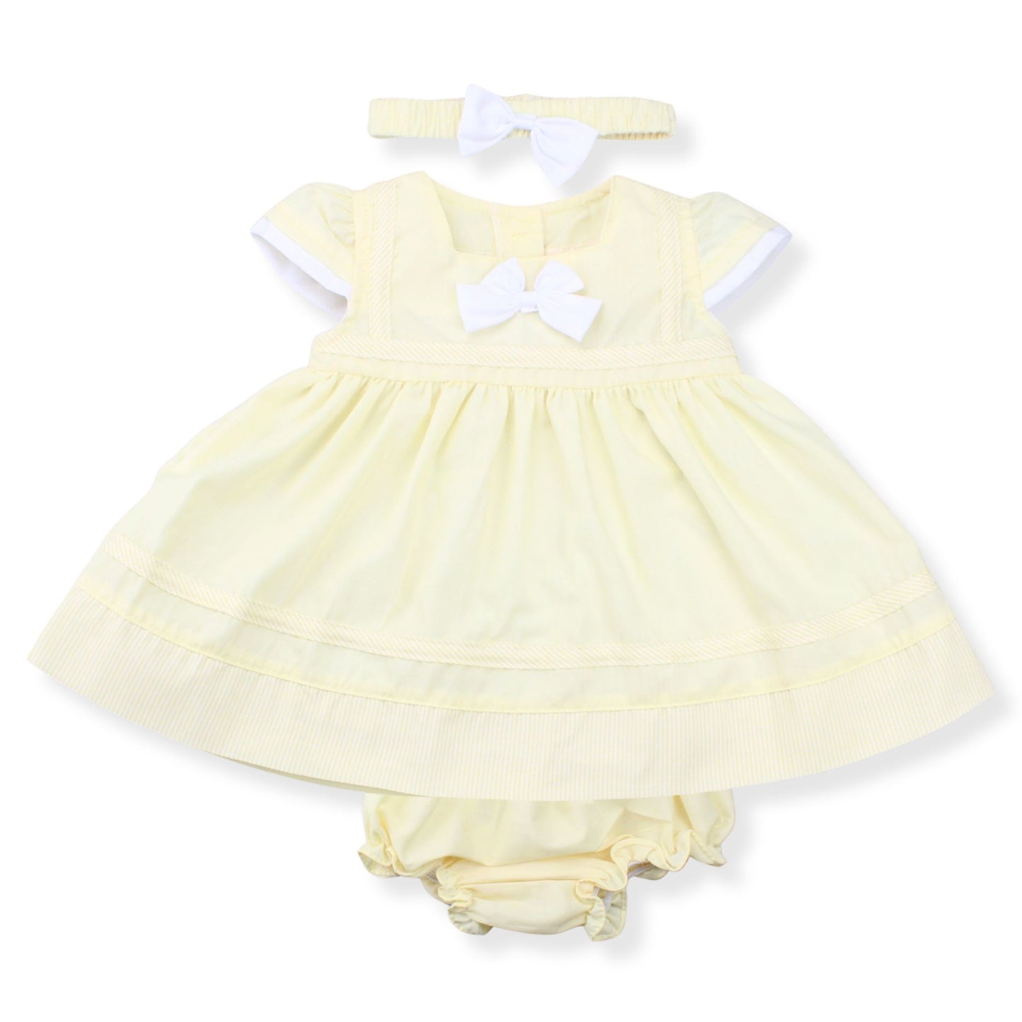 Yellow baby dress with white bow and matching bloomers on a white background