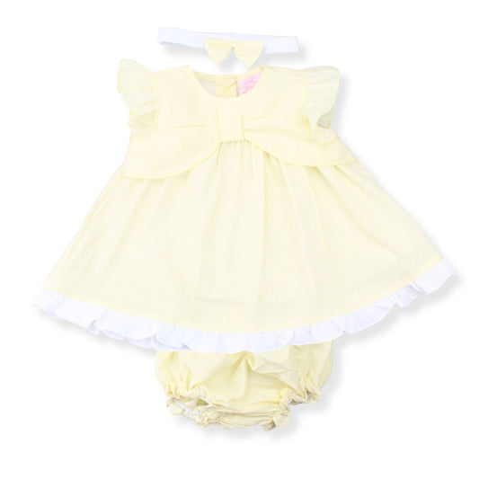 Yellow baby dress with white trim on a white background