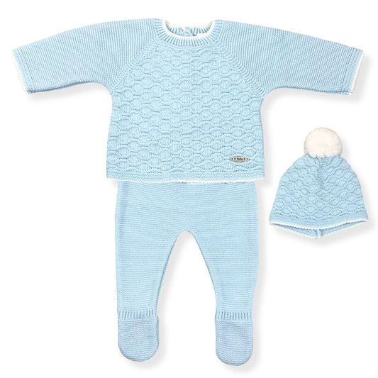 Baby blue knitted outfit with sweater, pants, and hat on a white background