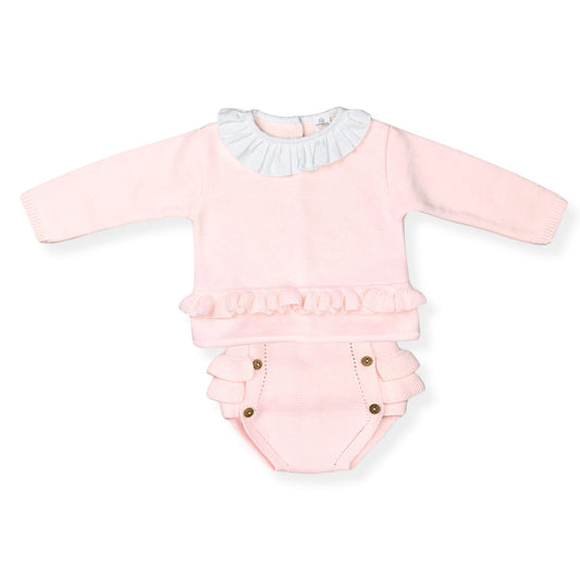 Pink baby outfit with ruffled details on a white background