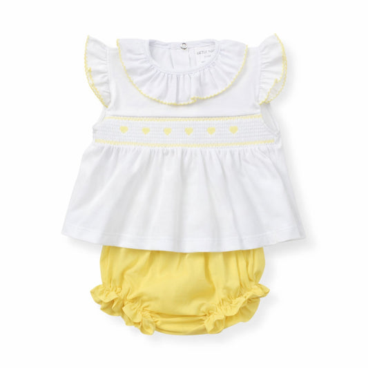 White top with yellow trim and yellow bloomers on a white background