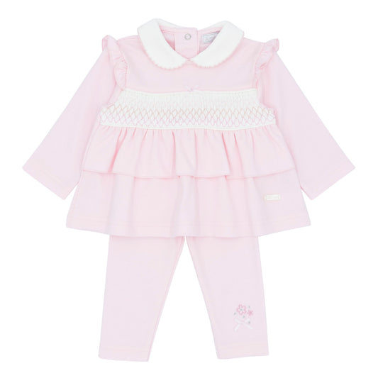 Pink baby outfit with white collar on a white background