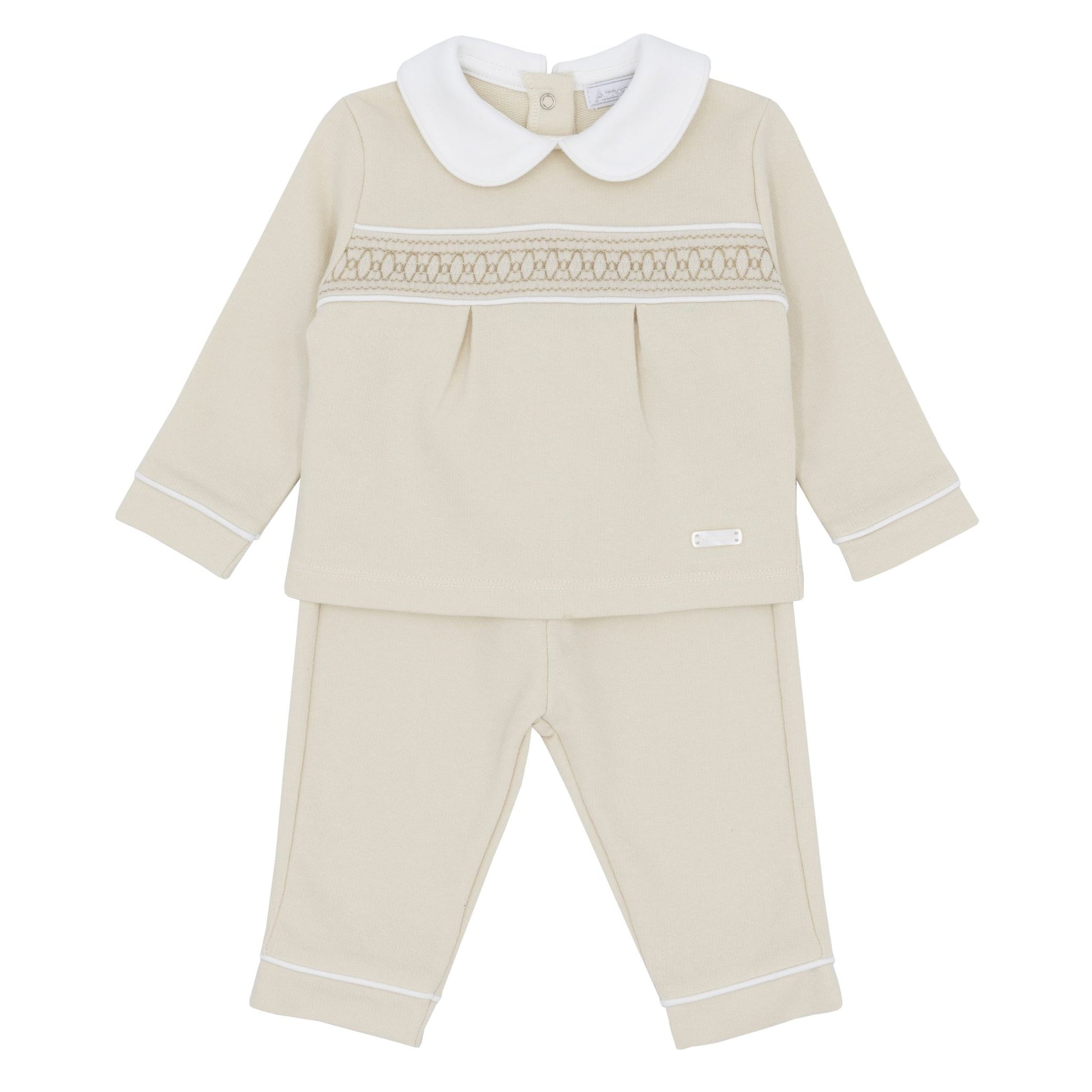 Beige baby outfit with white collar and trim on a white background