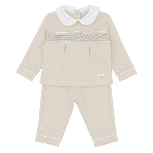 Beige baby outfit with white collar and trim on a white background