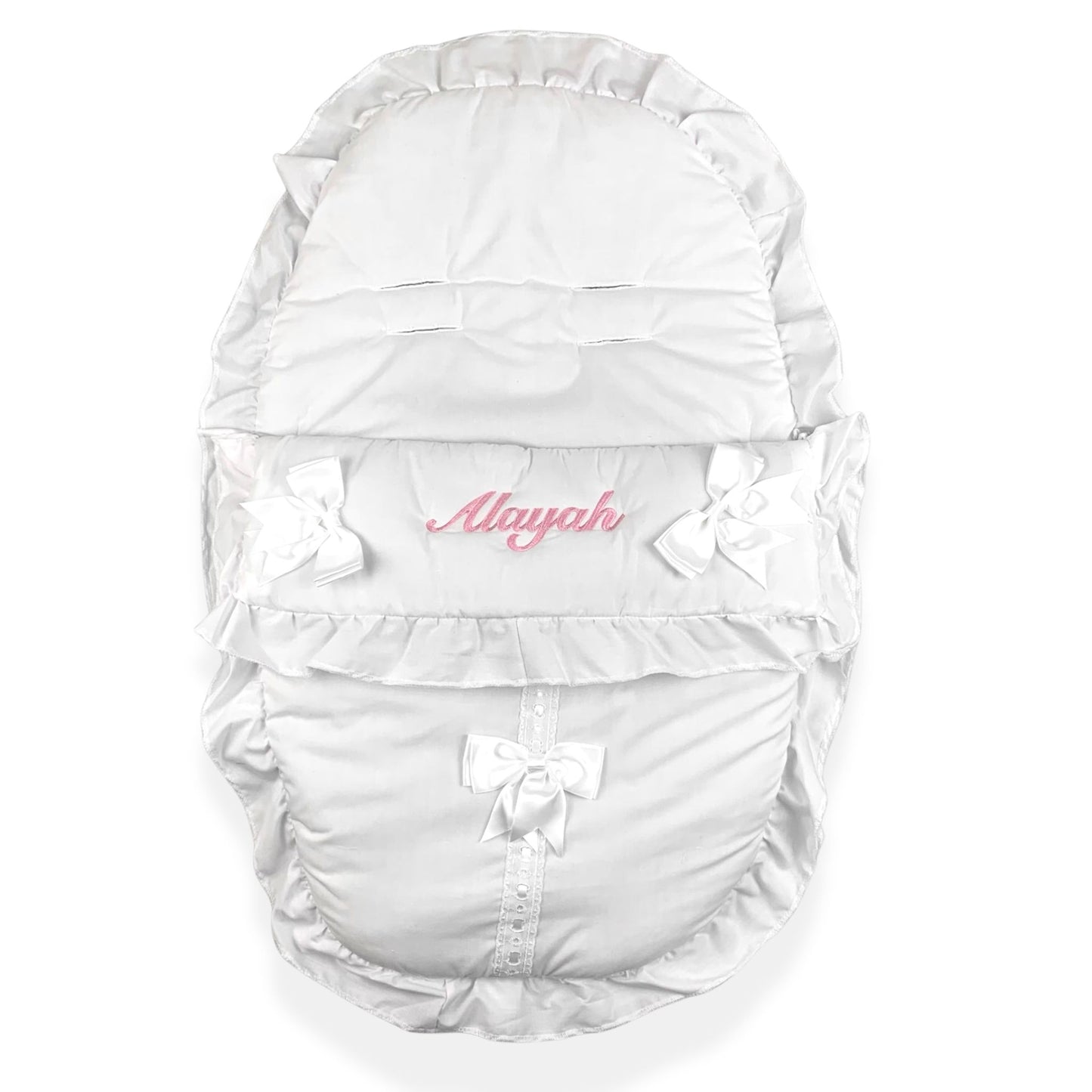 White baby carrier with ruffles and bows on a white background