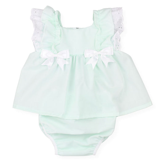 Mint green baby romper with white ruffled sleeves and bows on a white background