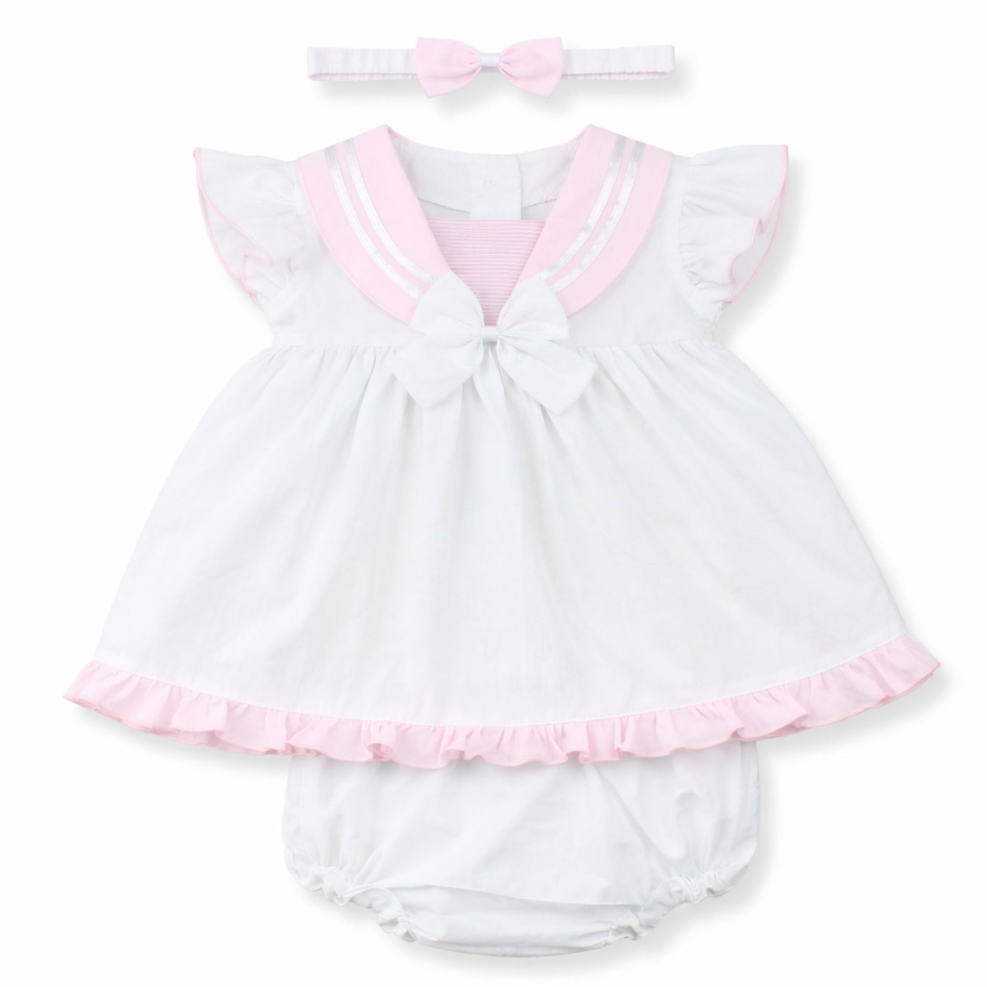 White baby dress with pink trim and matching headband on a white background