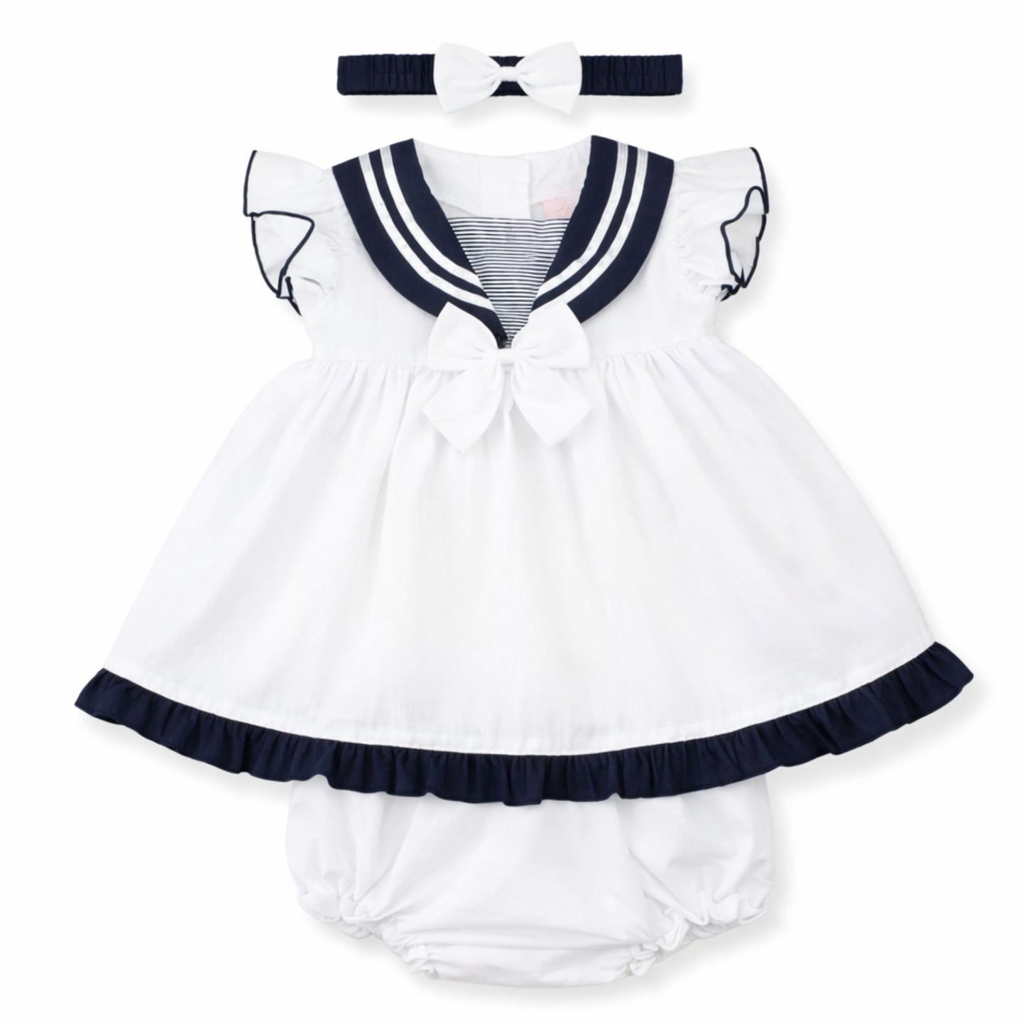 White baby dress with navy trim and matching headband on a white background
