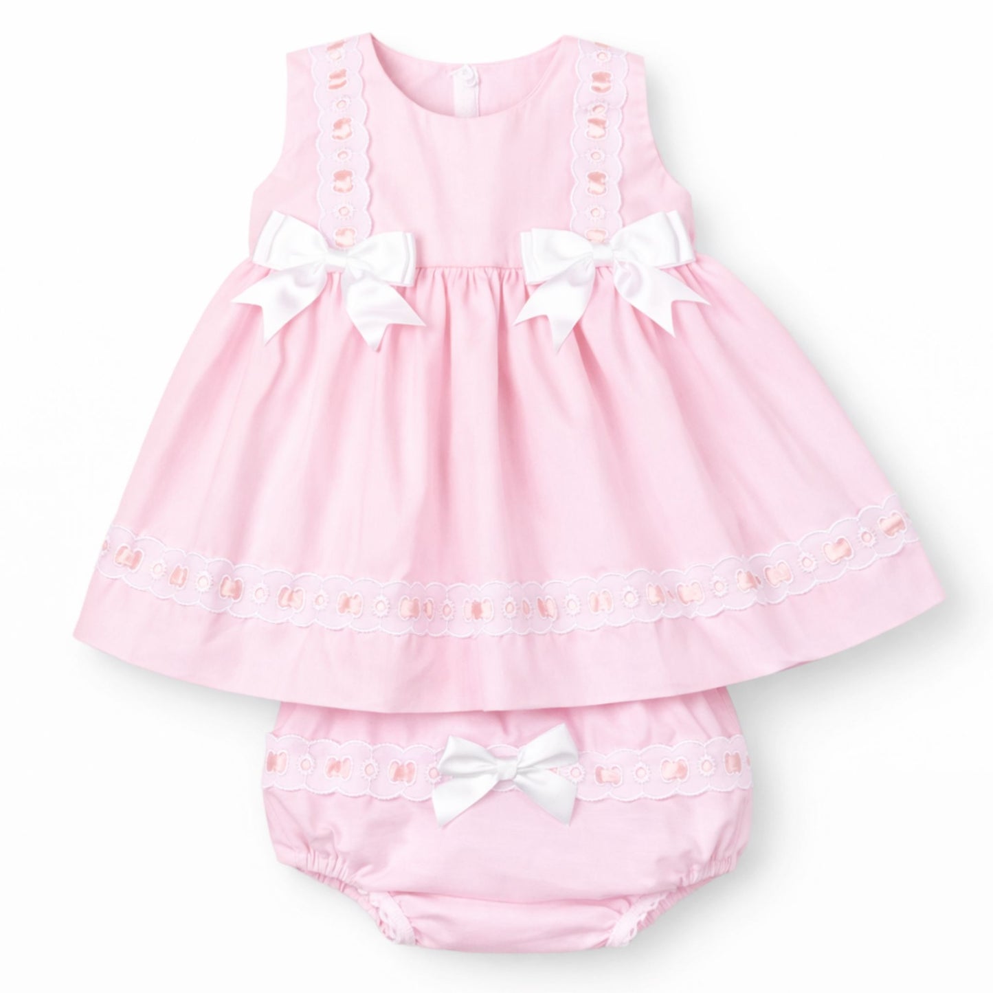 Pink baby dress with white bows on a white background