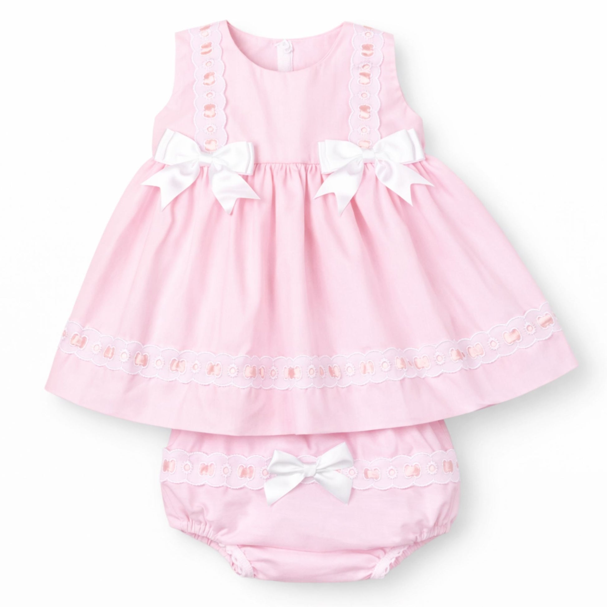 Pink baby dress with white bows on a white background