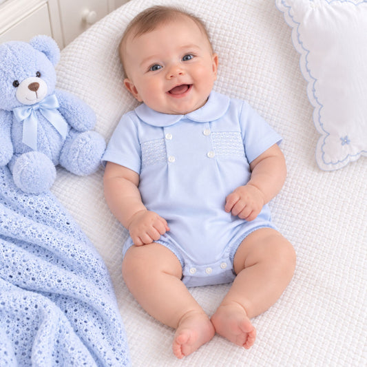 baby boys blue romper with white buttons and white smocking 