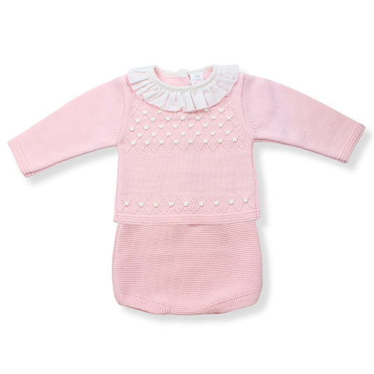 Pink baby outfit with ruffled collar on a white background