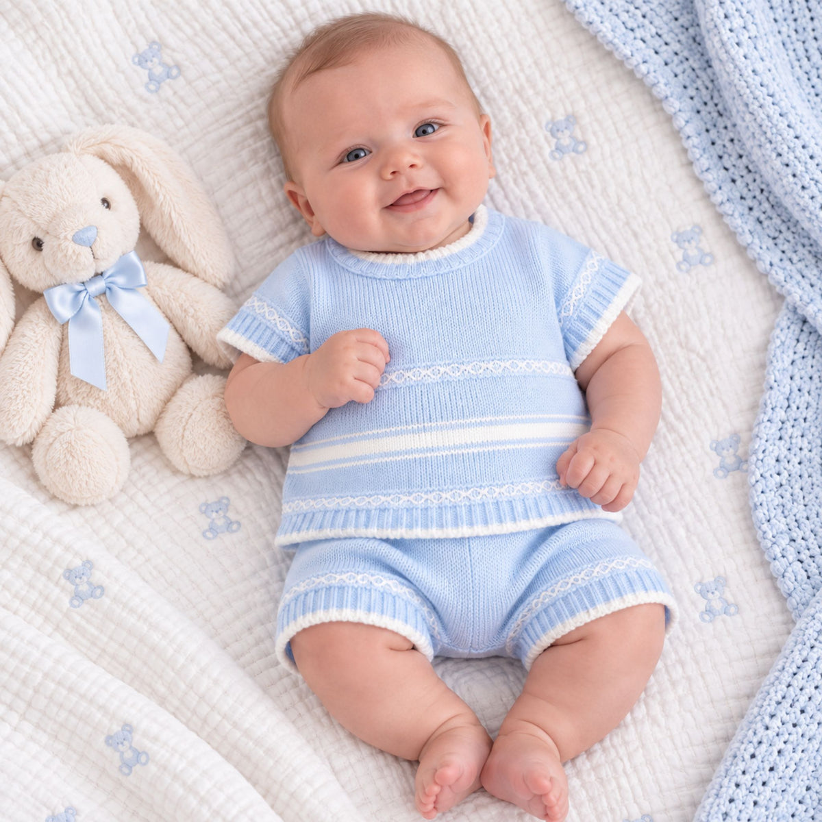 Light blue baby outfit with short sleeves and shorts on a white background