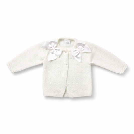 White knitted cardigan with bow details on a white background