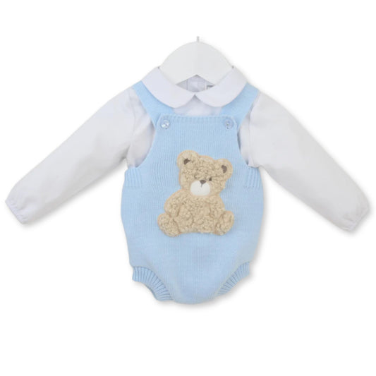 Baby outfit with blue knitted romper and teddy bear design on a white background