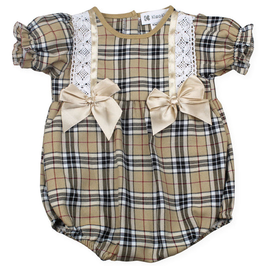 Plaid baby romper with lace details and bows on a white background