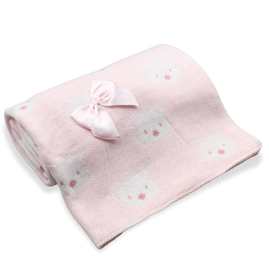 Pink baby blanket with bow and bear patterns on a white background