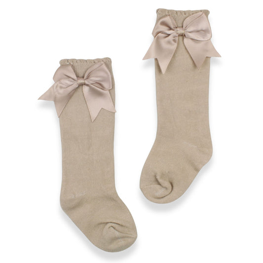 Pair of beige socks with large bows on a white background