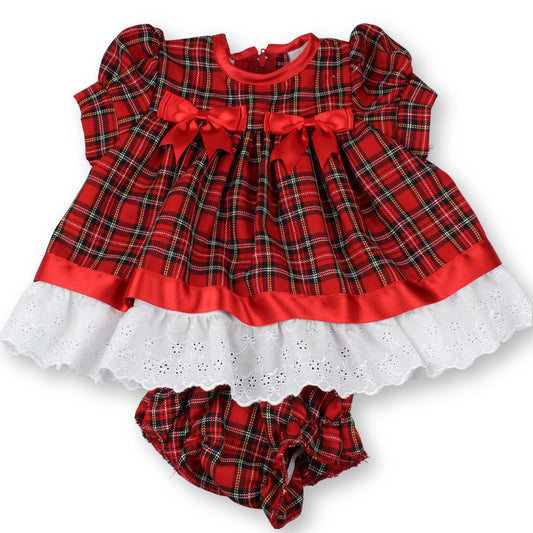 Red plaid baby dress with white ruffled bottom on a white background