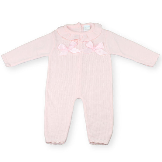 Pink baby onesie with bow details on a white background