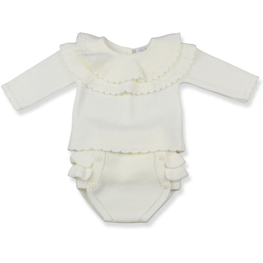 White baby romper with ruffled details on a white background