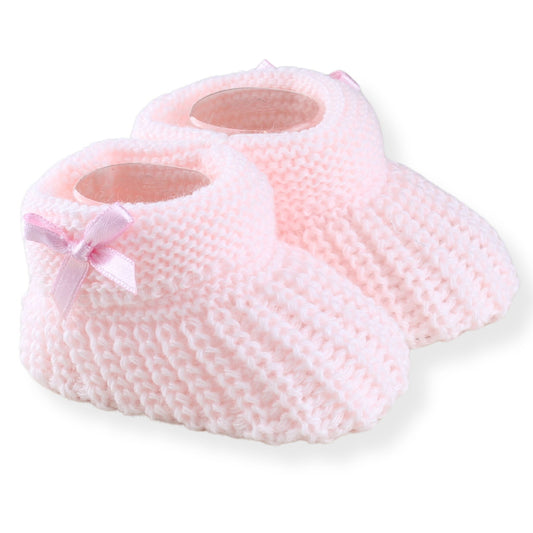 Pink baby booties with a bow on a white background