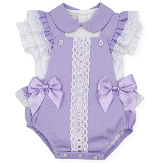 Lavender baby romper with lace details and bows on a white background