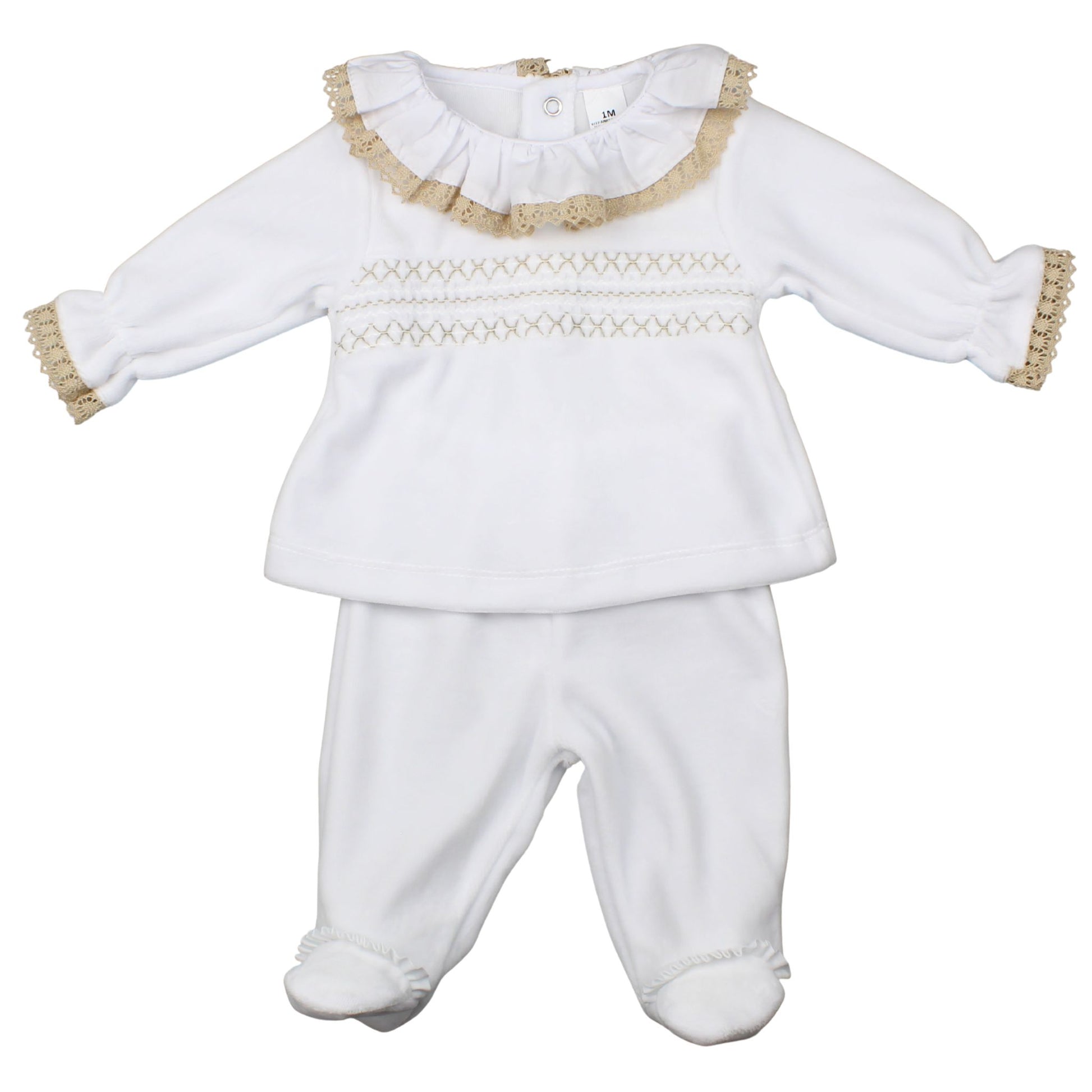 White baby outfit with ruffled collar and gold trim on a white background