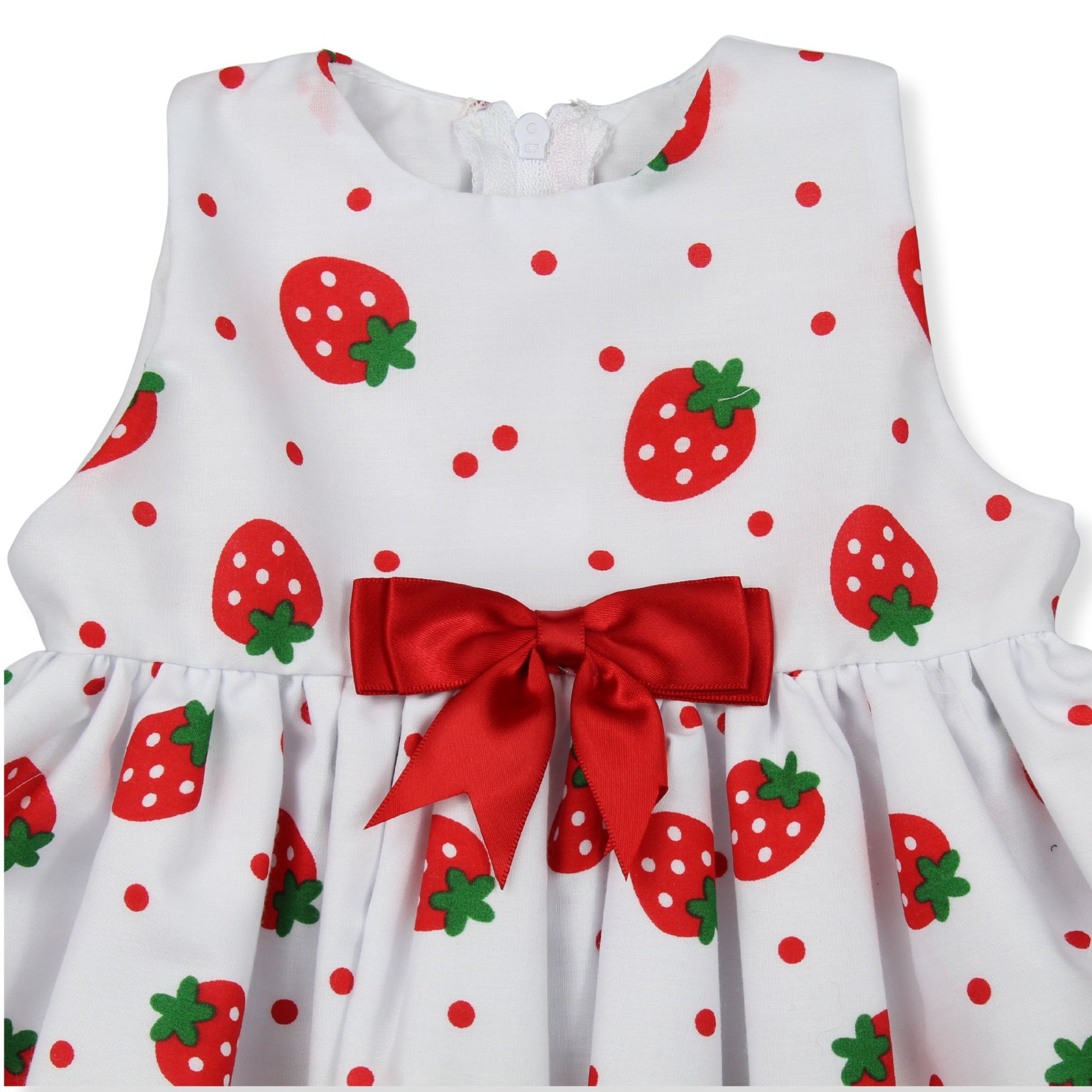 White dress with red strawberry pattern and a large red bow on a white background