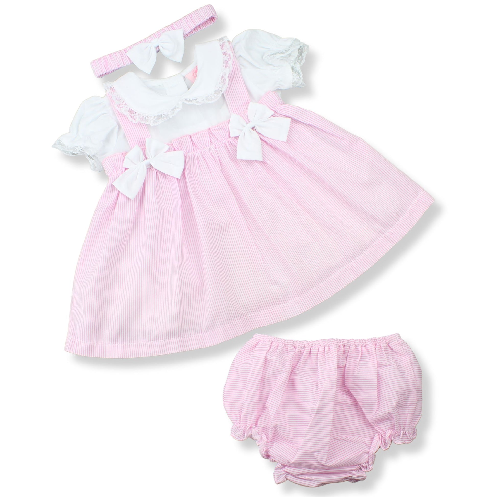 Pink baby dress with white ruffles and matching bloomers on a white background