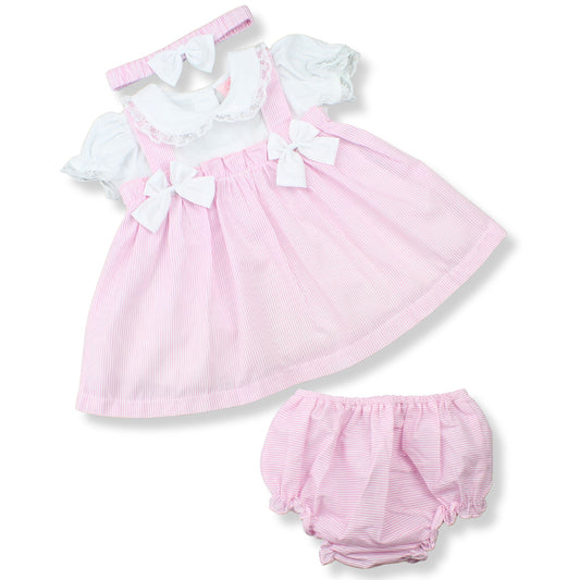 Pink baby dress with white ruffles and matching bloomers on a white background
