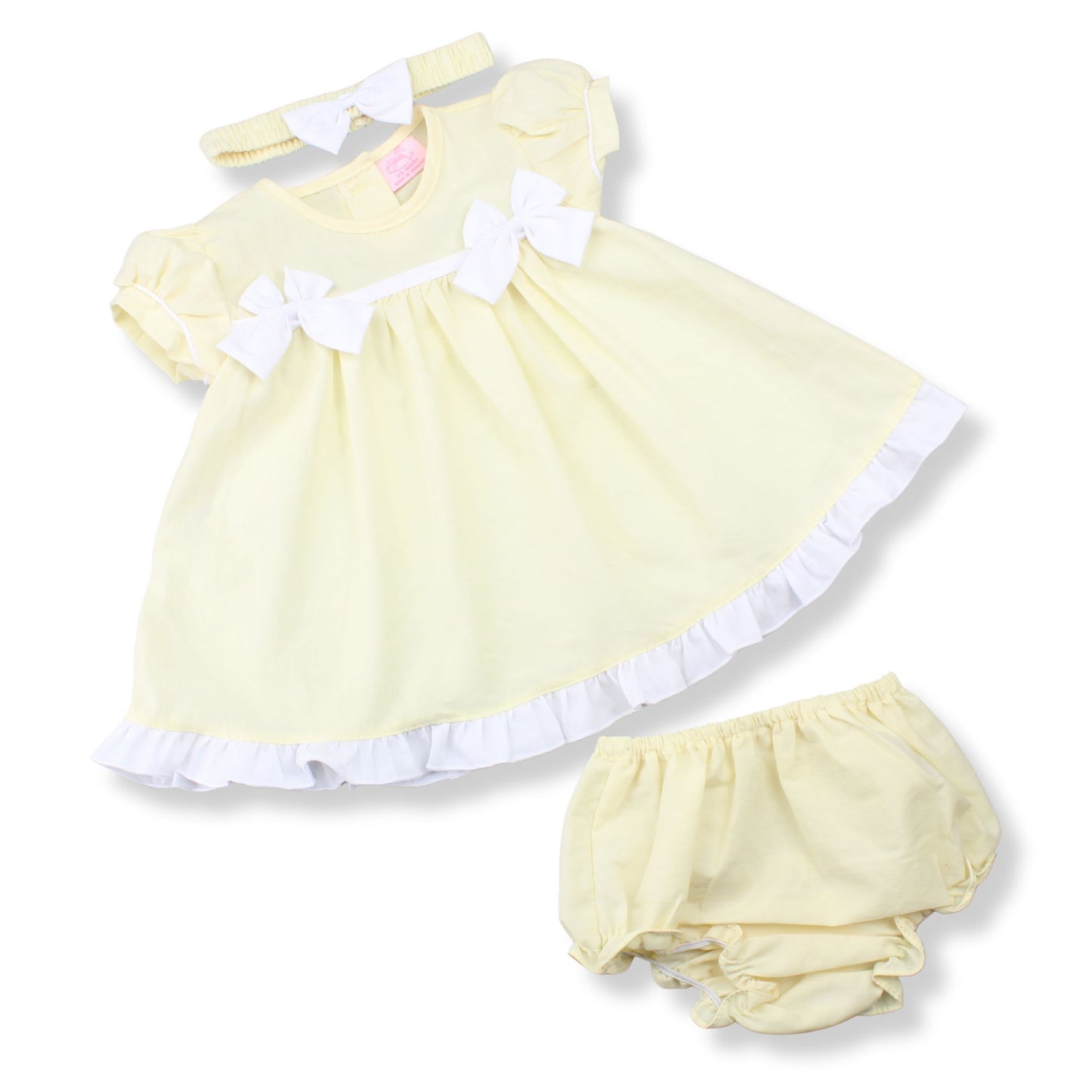 Yellow baby dress with white trim and matching bloomers on a white background
