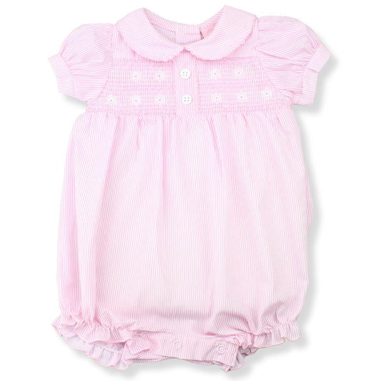 Pink baby romper with ruffled details on a white background
