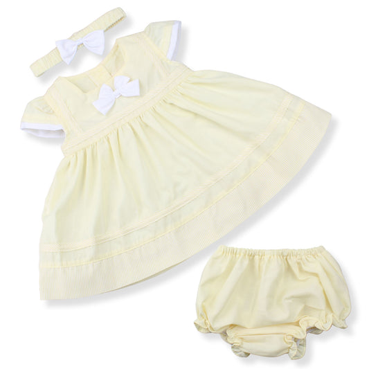 Yellow baby dress with matching bloomers and headband on a white background