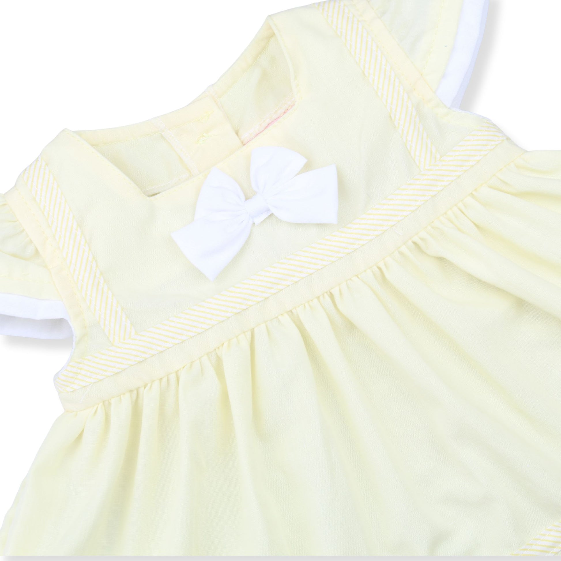 Light yellow dress with a white bow on a white background
