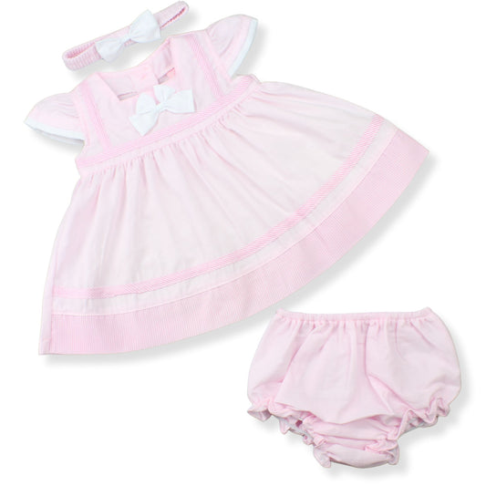 Pink baby dress with matching bloomers on a white background