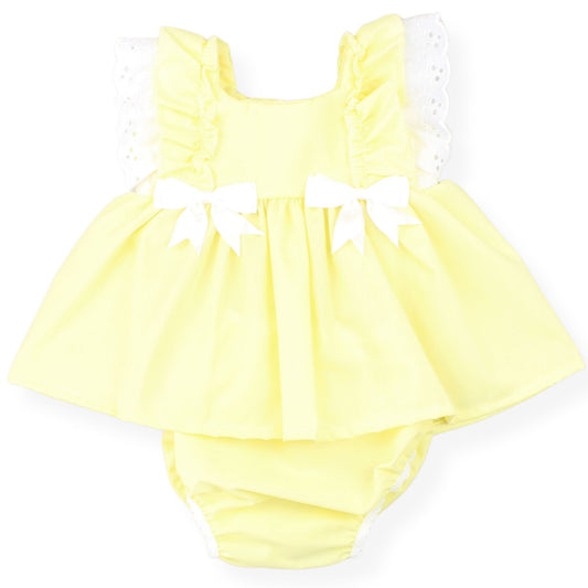 Yellow baby romper with white bows on a white background