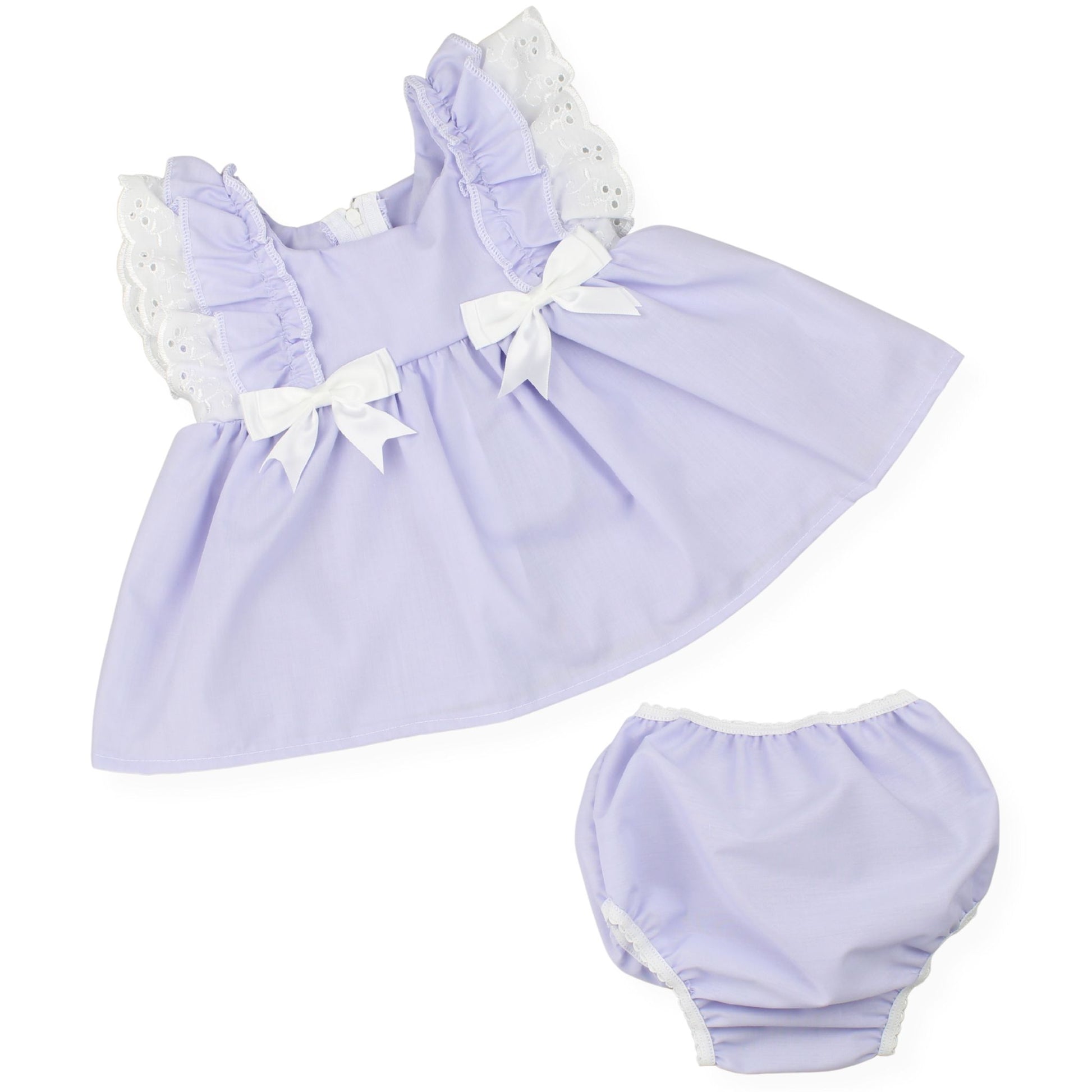Lavender baby dress with white bows and matching bloomers on a white background