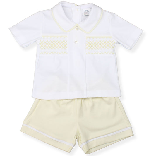 White shirt with yellow smocking and yellow shorts for a baby or toddler on a white background
