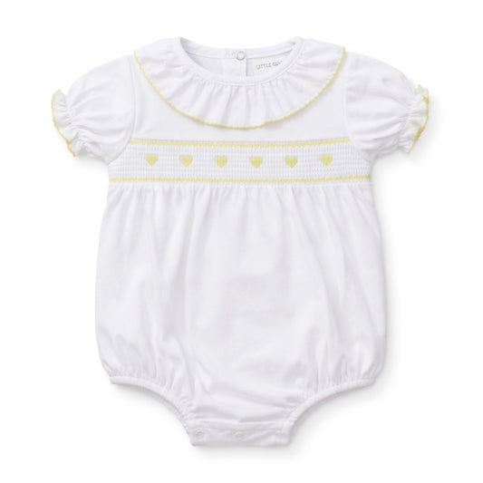 White baby romper with yellow heart details on a white background