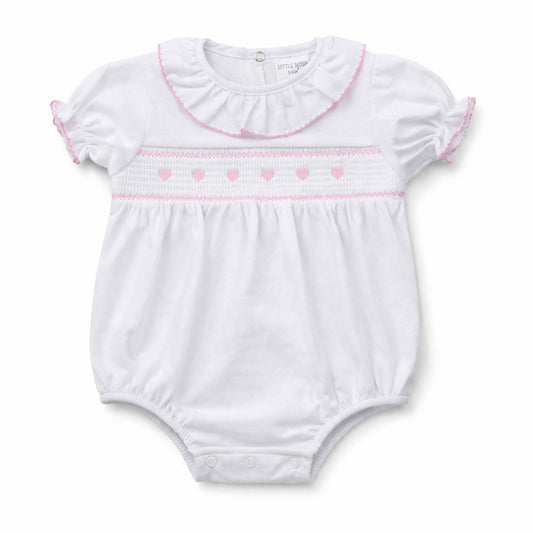 White baby romper with pink trim on a white background