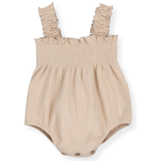 Beige baby romper with ruffled straps on a white background