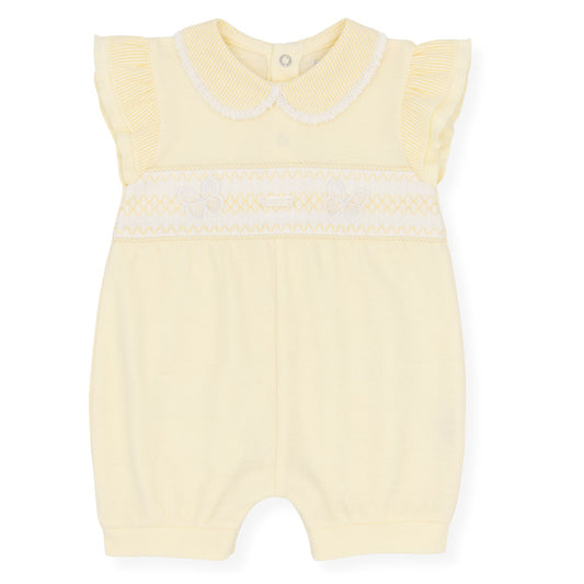 Yellow baby romper with white trim on a white background