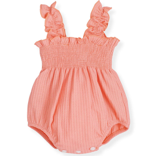 Coral baby romper with ruffled straps on a white background