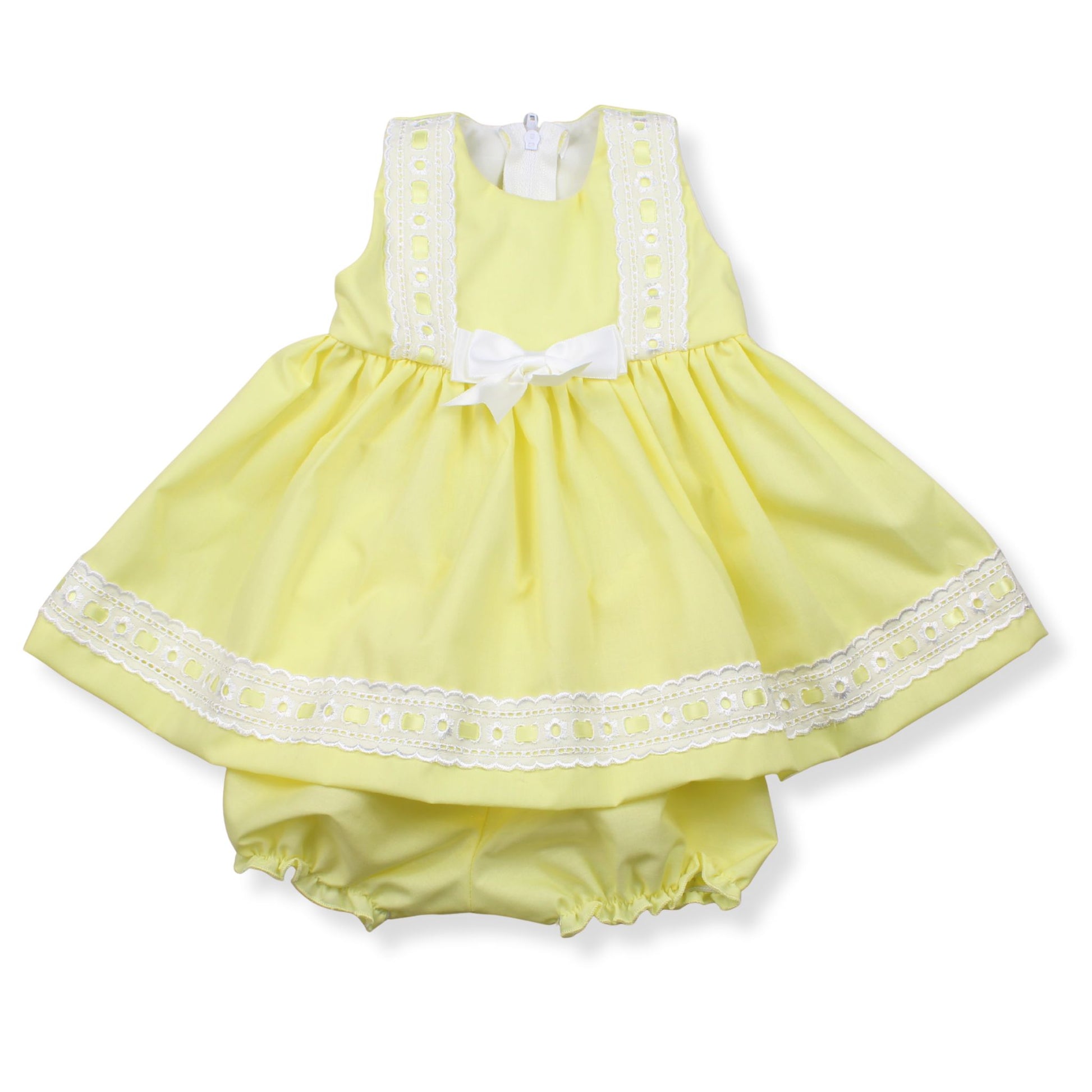 Yellow baby dress with white lace details on a white background