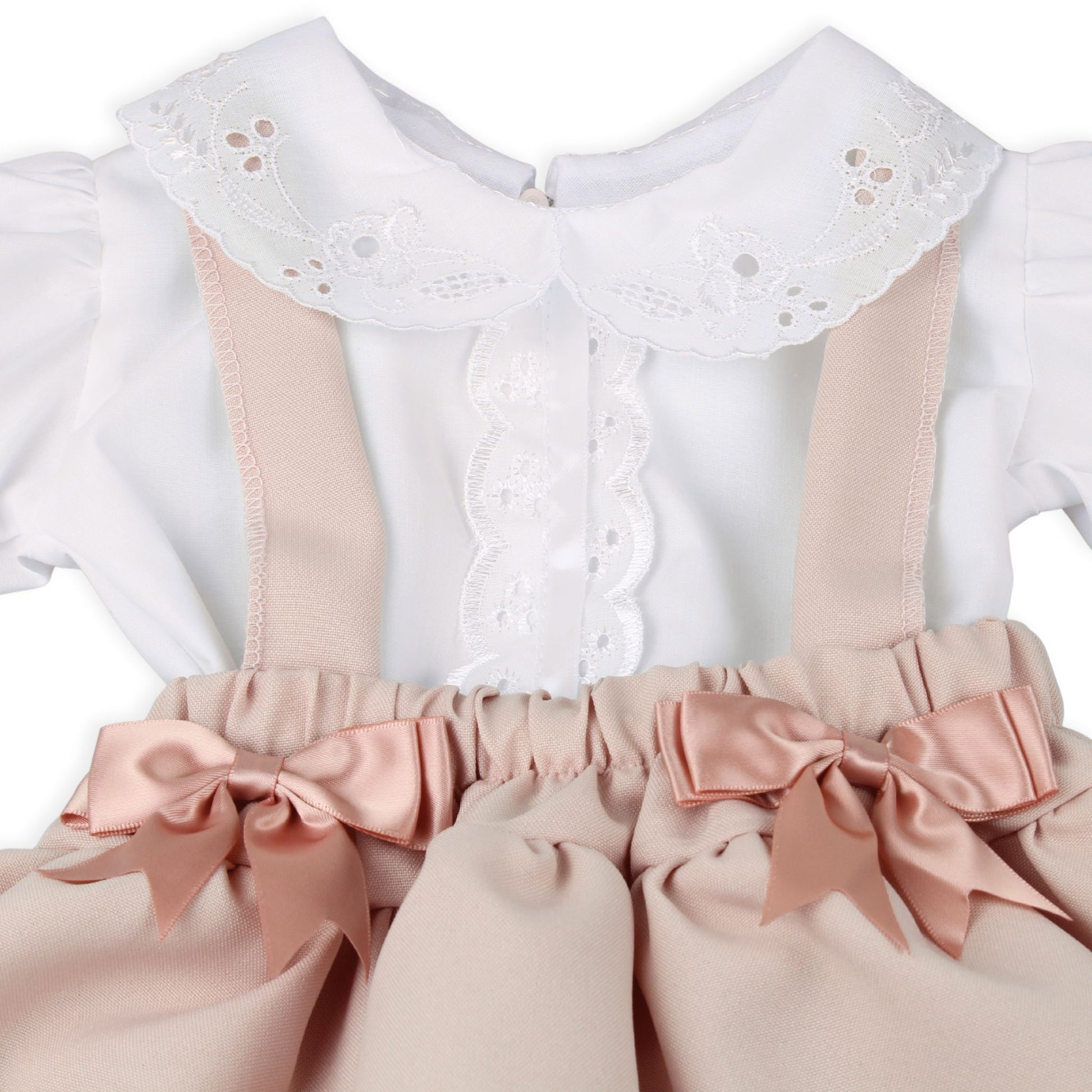 White blouse with pink ribbons and bows on a white background