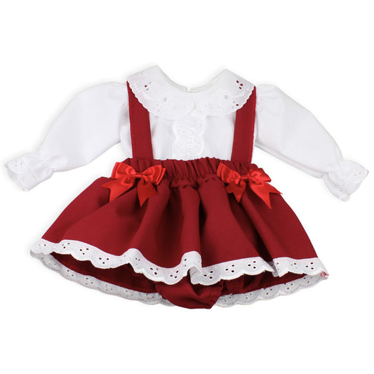 Red dress with white lace details and suspenders on a white background