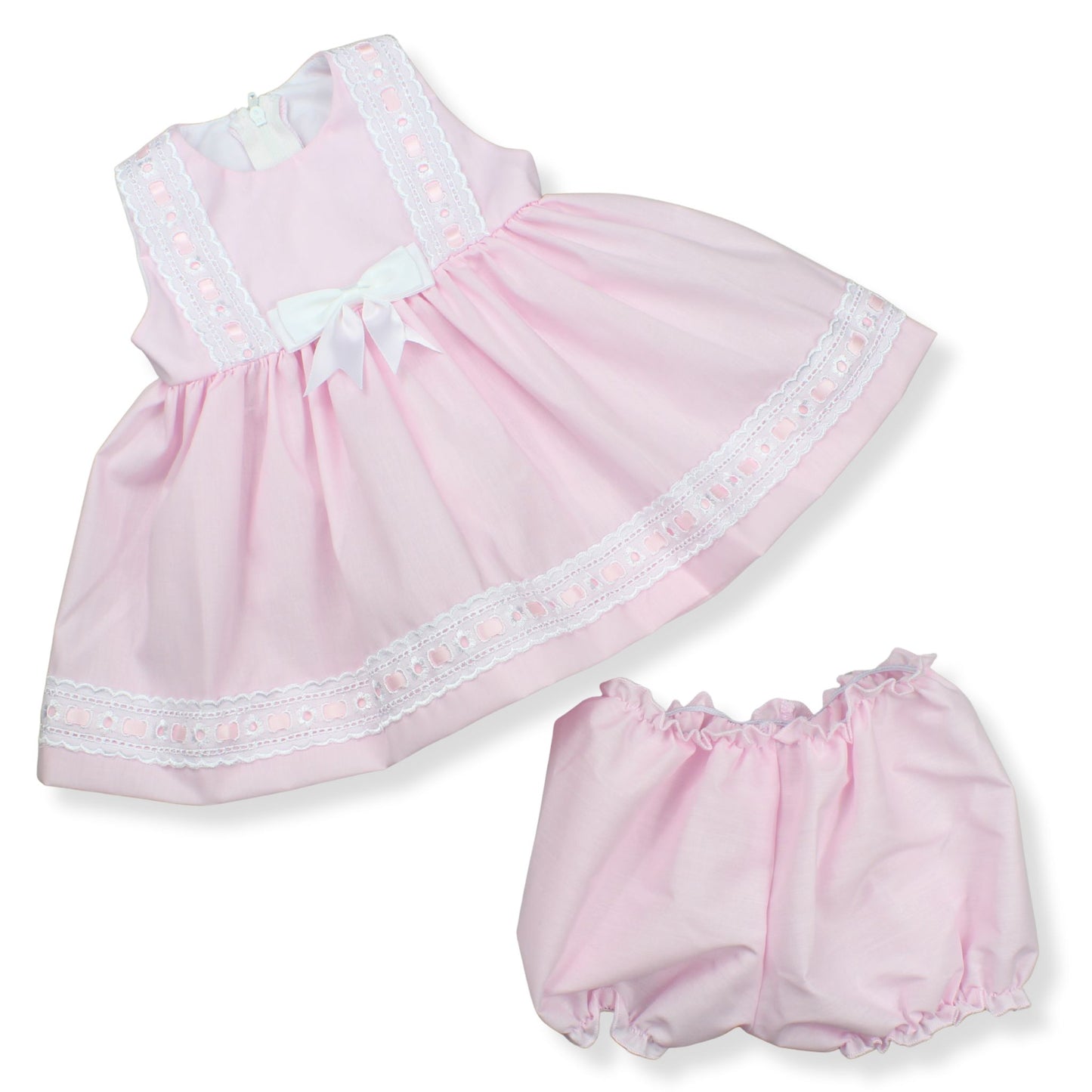 Pink baby dress with white trim and matching bloomers on a white background