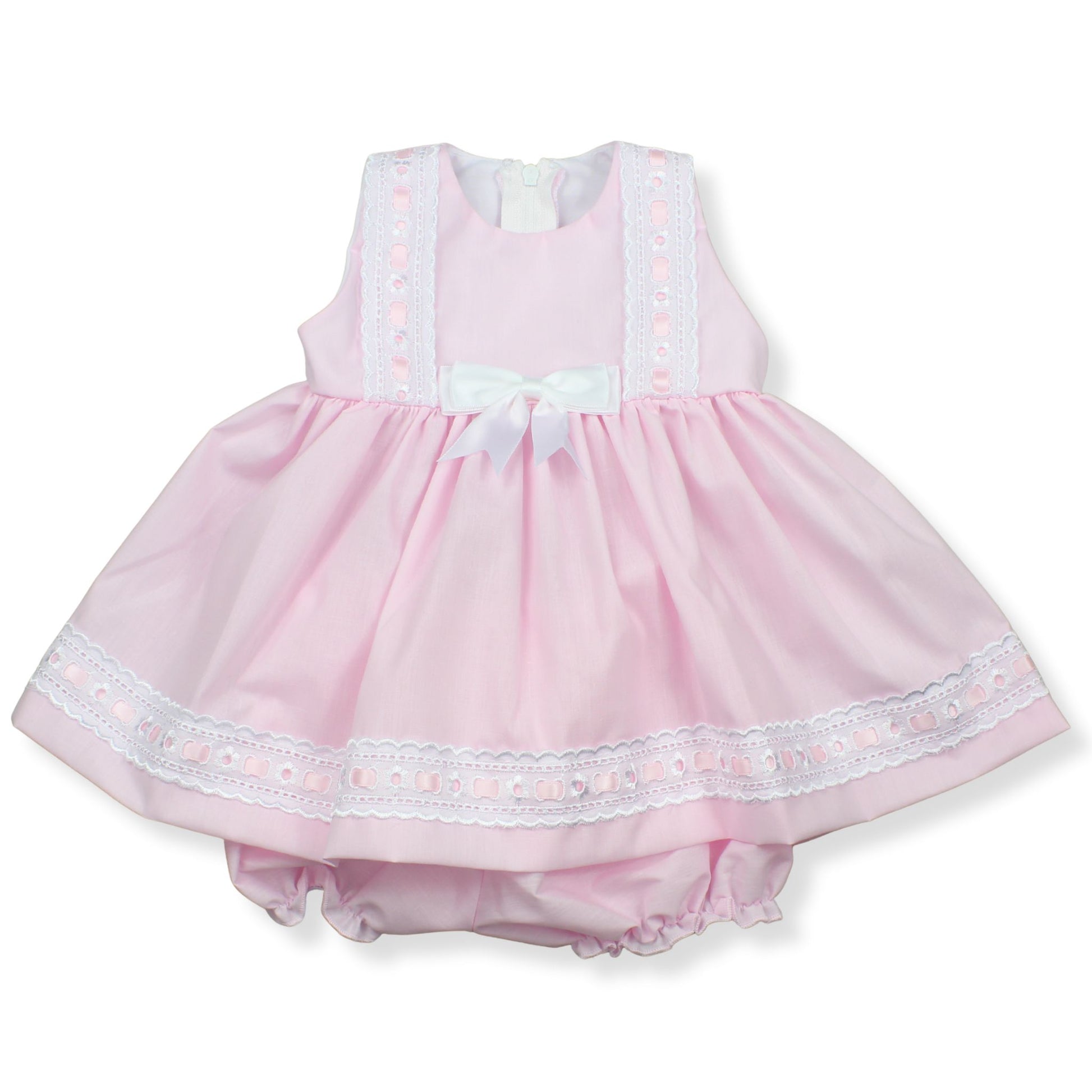 Pink baby dress with white lace trim on a white background