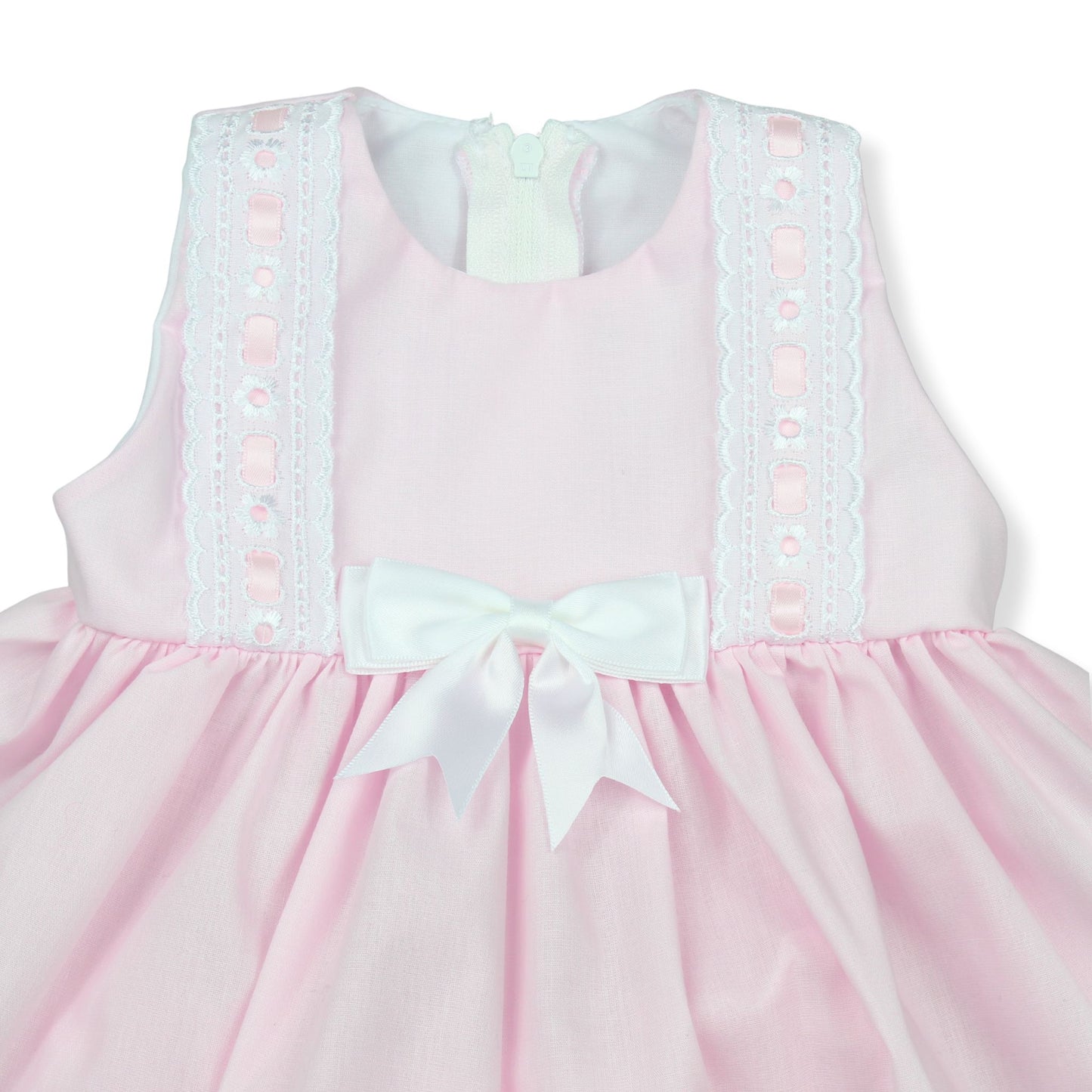 Pink dress with white lace details and a bow on a white background